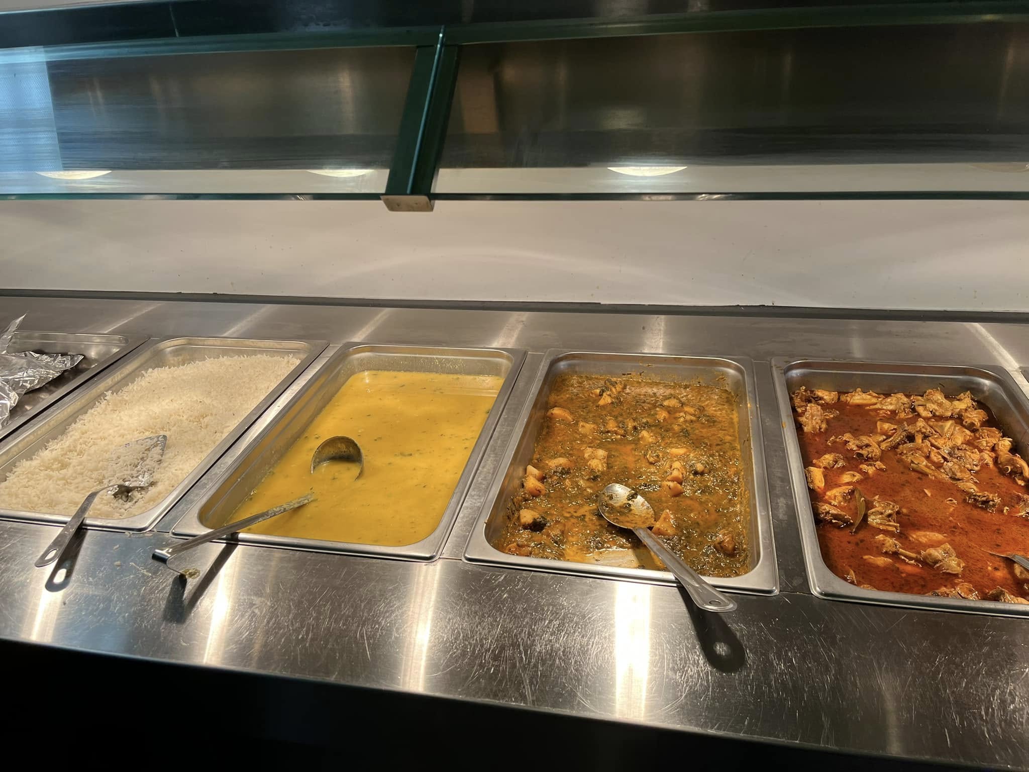 Steam pans of basmati rice, daal and curries in the Desi Meal kitchen